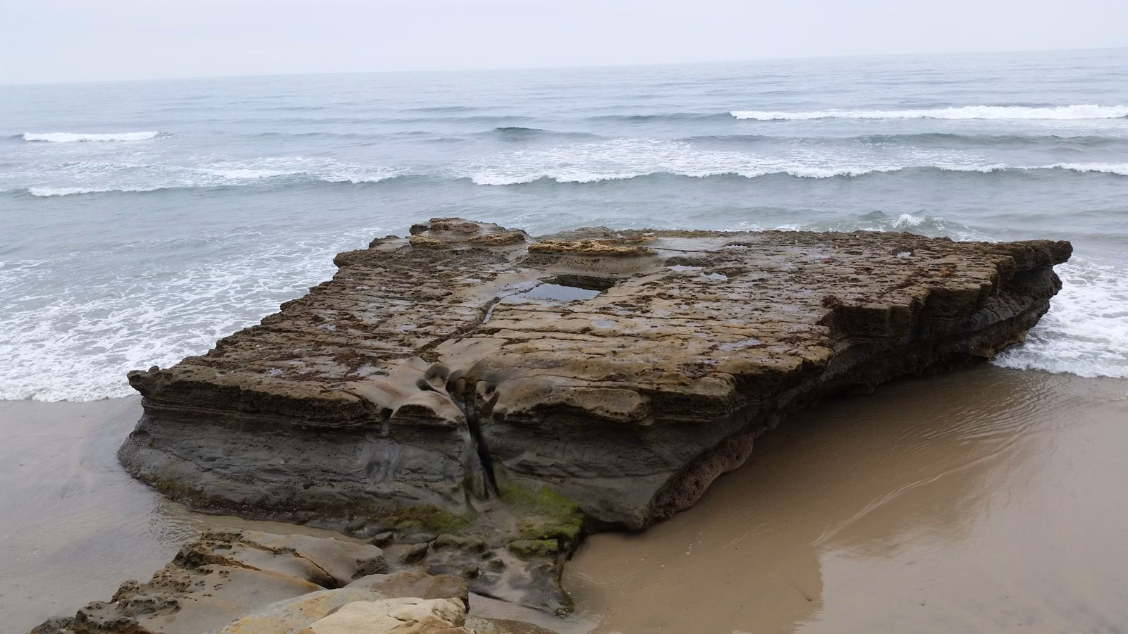 Flat Rock, a sandstone outcrop on the beach at low tide