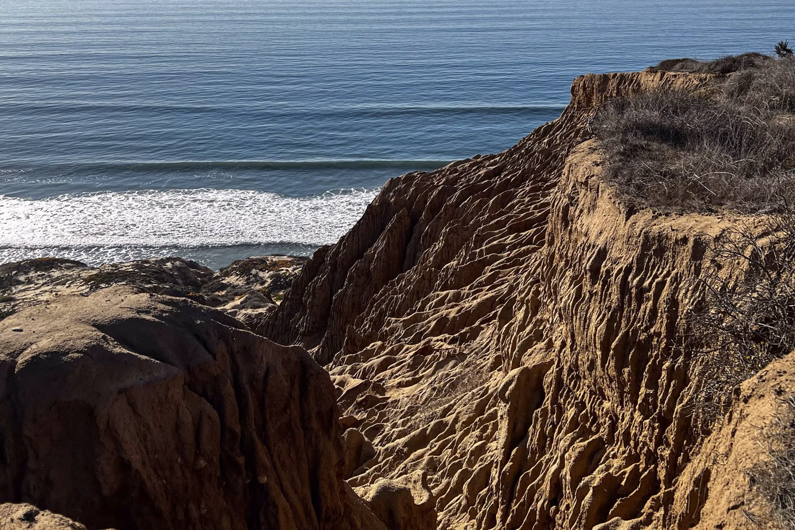 An eroded sandstone ravine dropping toward the Pacific